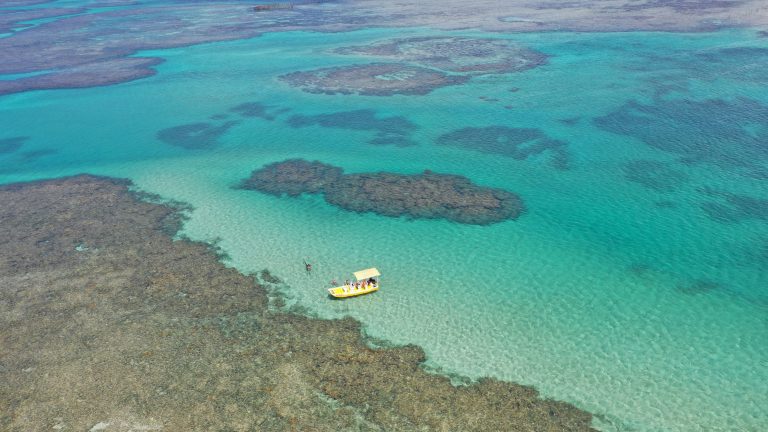 Panoramic,View,Of,A,Rustic,Boat,Among,Coral,Reefs,And