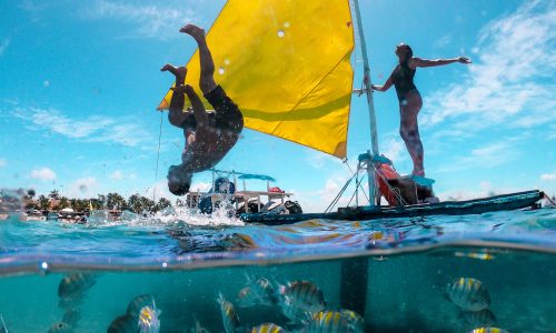 Young couple swimming in the natural pools in Porto de Galinhas Pernambuco - Brazil