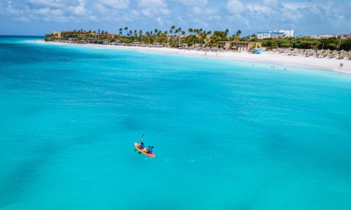 Couple,Kayaking,In,The,Ocean,On,Vacation,Aruba,Caribbean,Sea,
